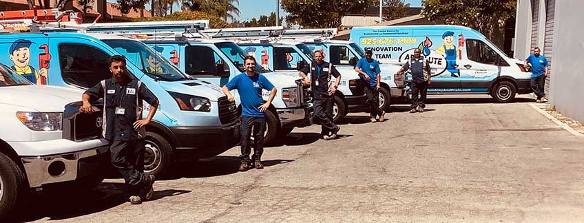 absolute plumbing and drain team in front of fleet of cars